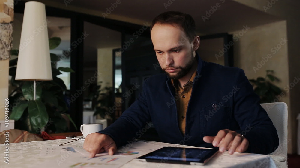 Modern businessman drinking espresso coffee in the cafe and working on tablet Modern businessman drinking espresso coffee in the cafe and working on tablet