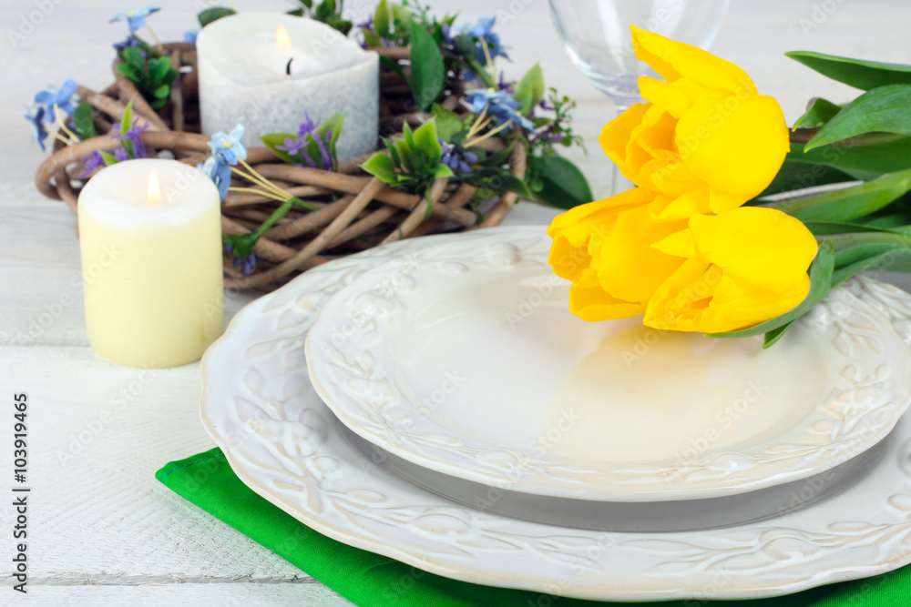 porcelain on the tissue near the yellow tulips on white wooden table porcelain on the tissue near the yellow tulips on white wooden table