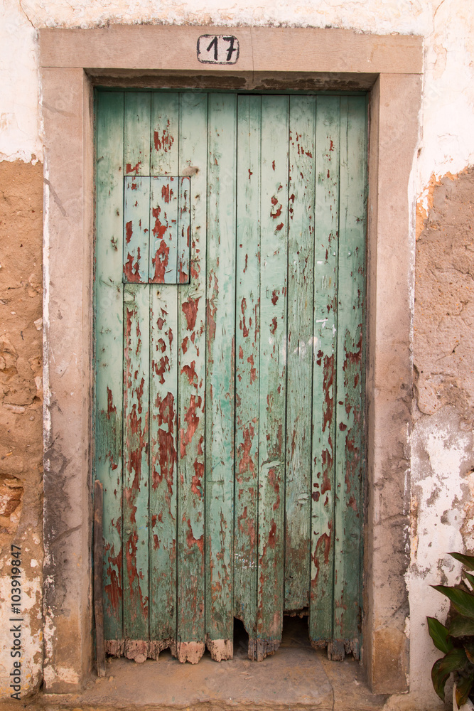 Close view of an old green wooden door.