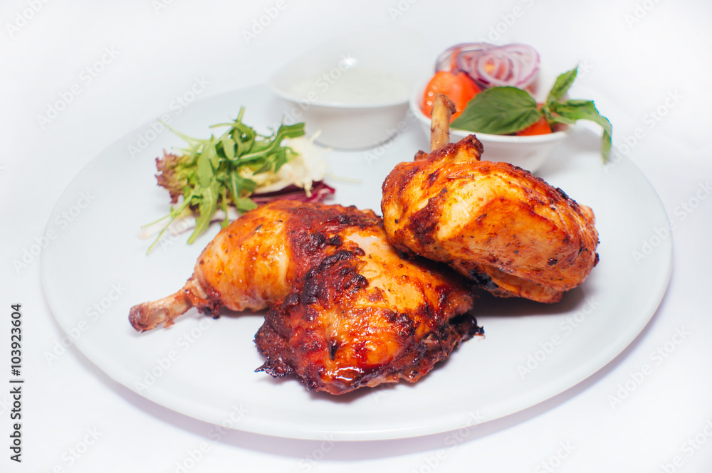 Fried chicken legs with salad from vegetables and greens with white sauce Fried chicken legs with salad from vegetables and greens with white sauce