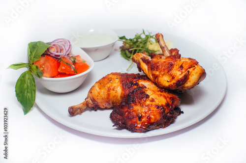 Fried chicken legs with salad from vegetables and greens with white sauce