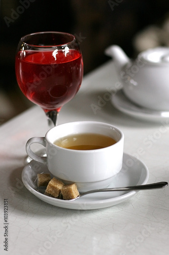 tea cup with glass of juce on the white table