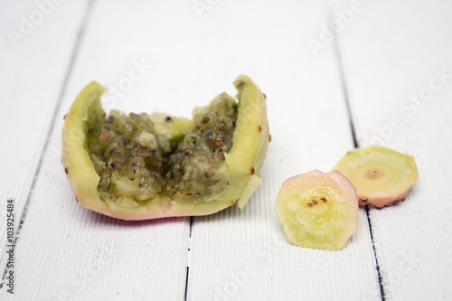 Opuntia ficus-indica cactus fruit opened on a white background photo