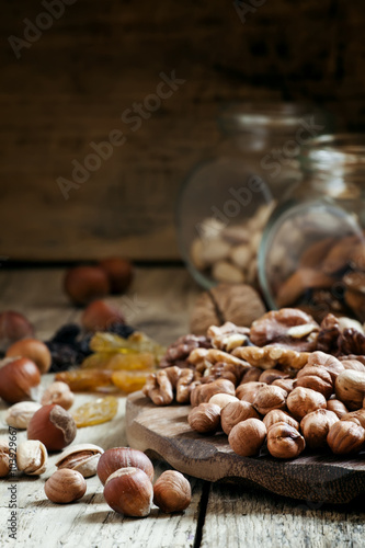 Nuts set of pistachios, walnuts, almonds and hazelnuts on a wood