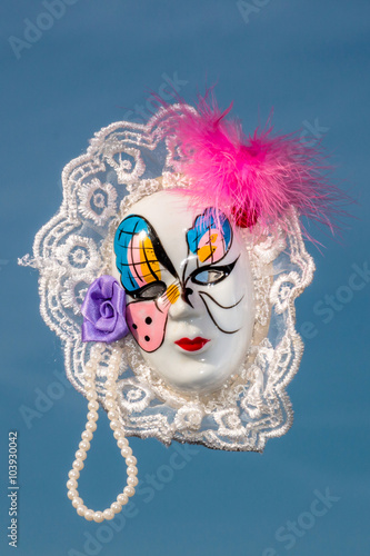 Fototapeta Naklejka Na Ścianę i Meble -  Porcelain carnival mask against blue sky