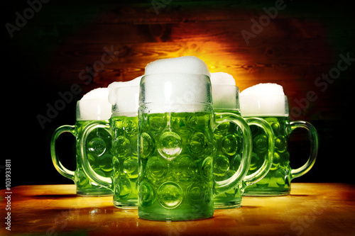 Five Green Beer Glasses on the Wooden Table