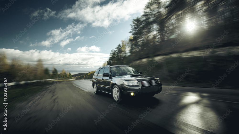 Black car fast drive on asphalt road at daytime