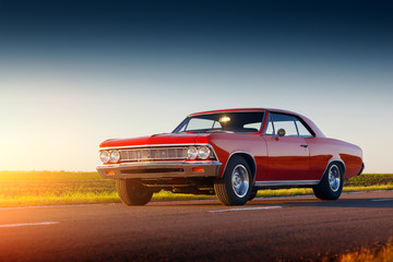 Wandcirkels Auto Rode retro auto bij zonsondergang  © Ivan Kurmyshov