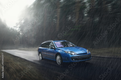 Blue car fast drive on wet road in rain at daytime © Ivan Kurmyshov