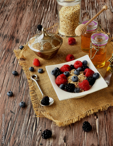 oatmeal with berries on a wooden table, selective focus