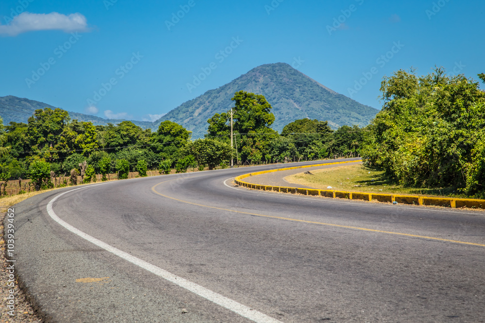 curve road view with volcano at background in blue sky curve road view with volcano at background in blue sky