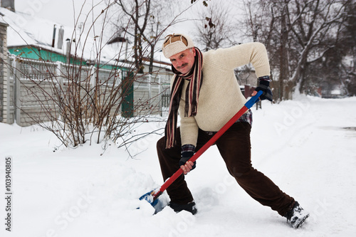man cleans snow