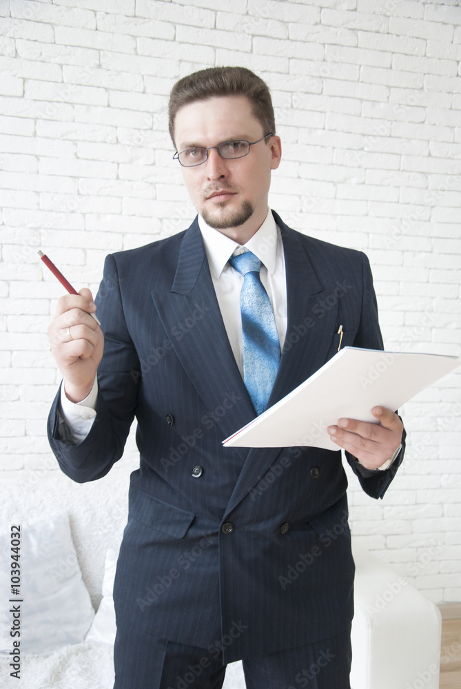 Businessman holding documents and giving instructions Businessman holding documents and giving instructions