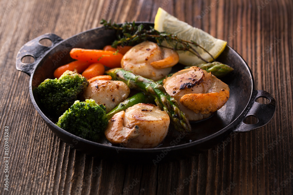 Fried scallops in a sauce with asparagus and broccoli Fried scallops in a sauce with asparagus and broccoli
