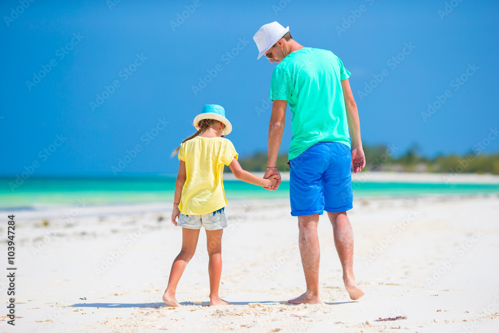 Little girl and young father during tropical beach vacation