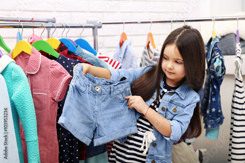 Little girl trying on a new jeans shorts