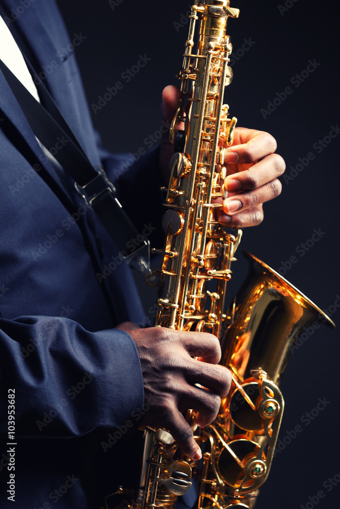 Fototapeta premium African American jazz musician playing the saxophone, closeup