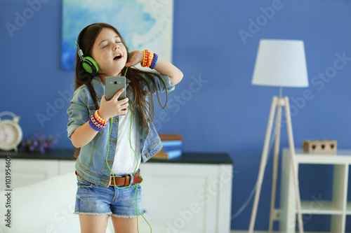 Cute little girl listening ...