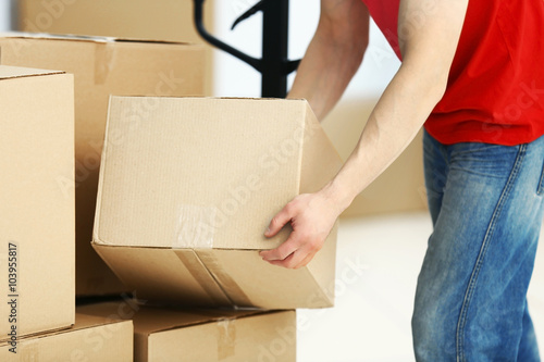 Man holding carton box in the room, close up © Africa Studio