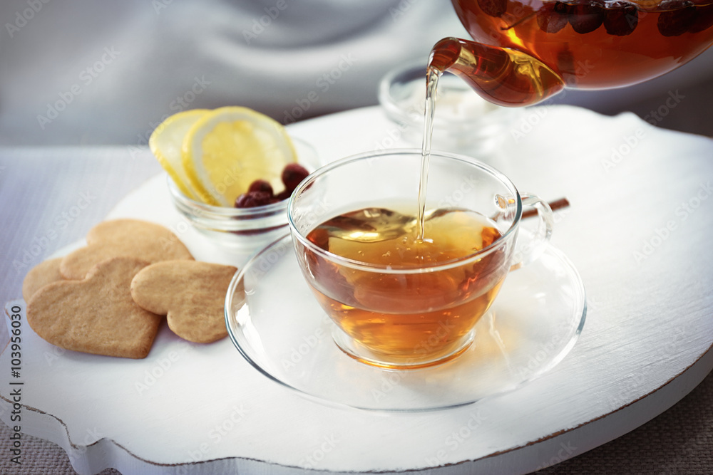 Pouring tea into cup, home atmosphere Pouring tea into cup, home atmosphere