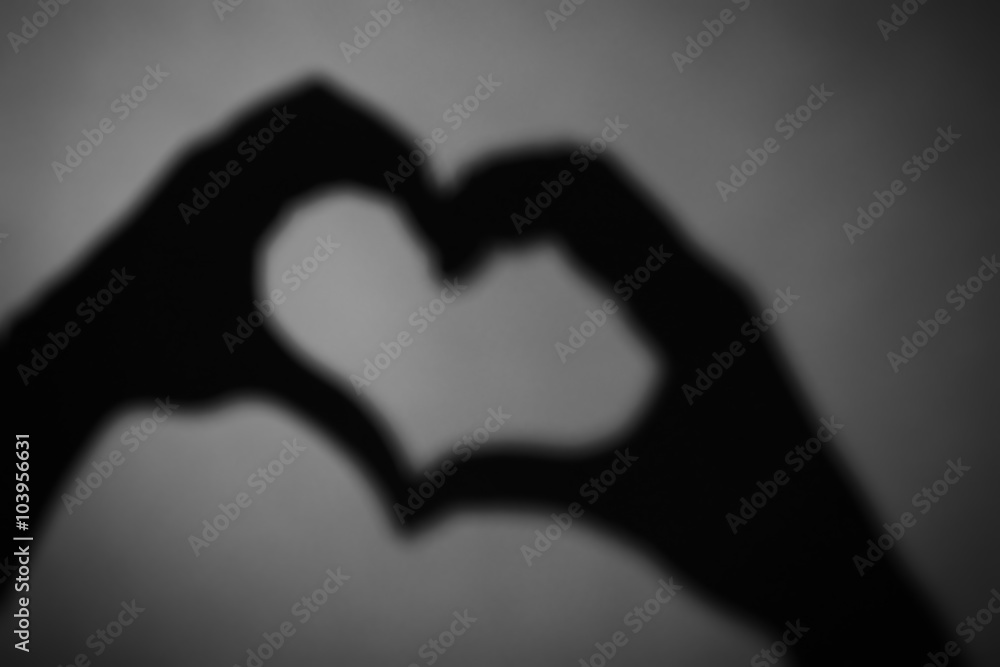 Obraz premium Hand shaped heart on dark background