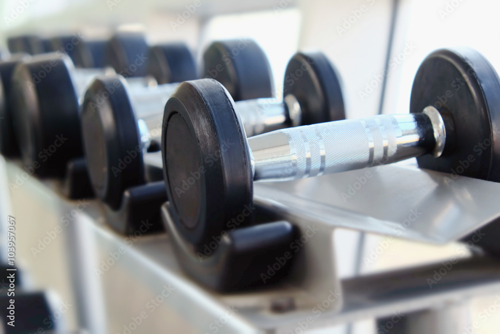 Fototapeta premium Dumb bells lined up in fitness room