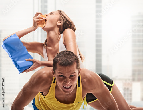 man doing push ups but woman eating