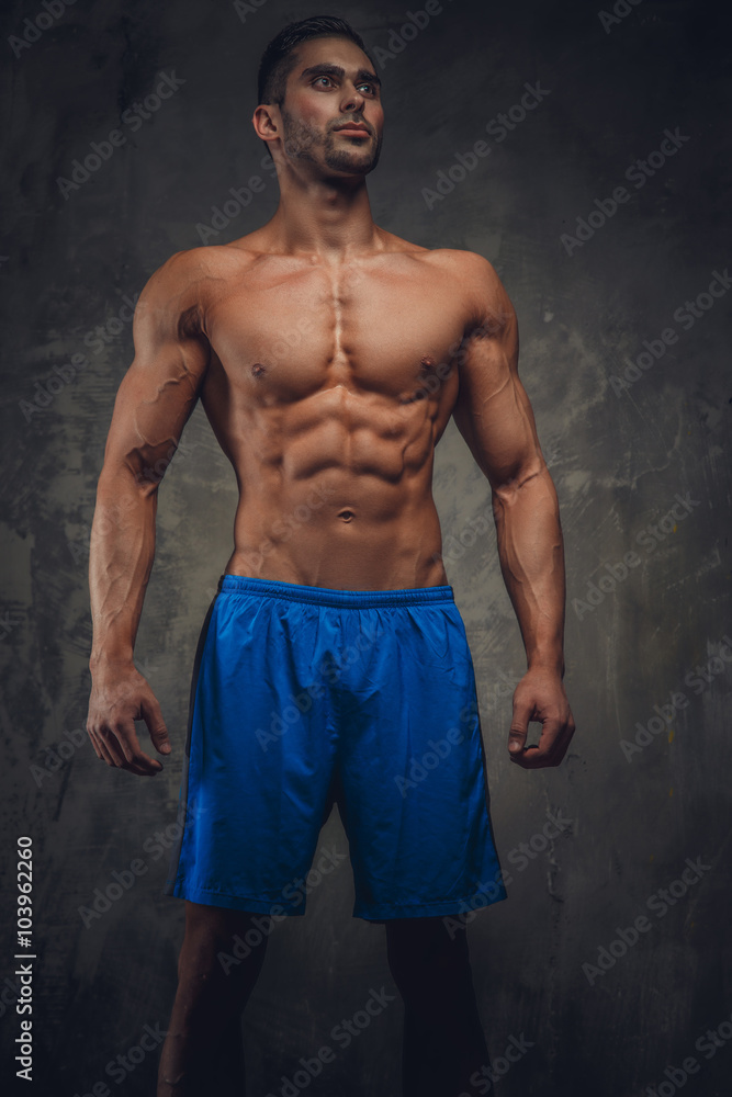 Fototapeta premium Shirtless muscular man in a blue shorts.