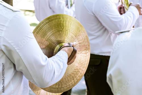 Fotografie military musician plays cymbal at the festival of brass bands