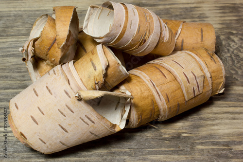 Fotografie Rolls of birch Bark on wooden