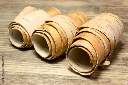 Tablou pe pânză Rolls of birch Bark on wooden