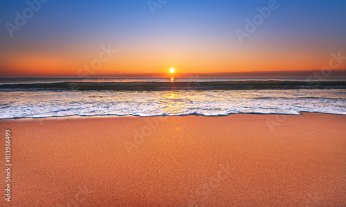 Fototapeta Naklejka Na Ścianę i Meble -  Majestic ocean sunset with a breaking wave.