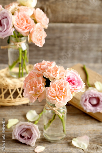 Bouquet of beautiful roses on a grey wooden table