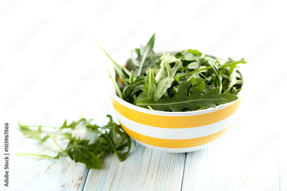 Fresh arugula leafs on a blue wooden table Fresh arugula leafs on a blue wooden table