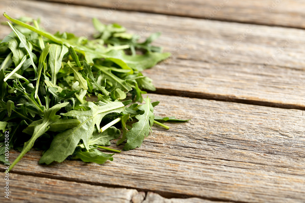 Fresh arugula leafs on a grey wooden table Fresh arugula leafs on a grey wooden table