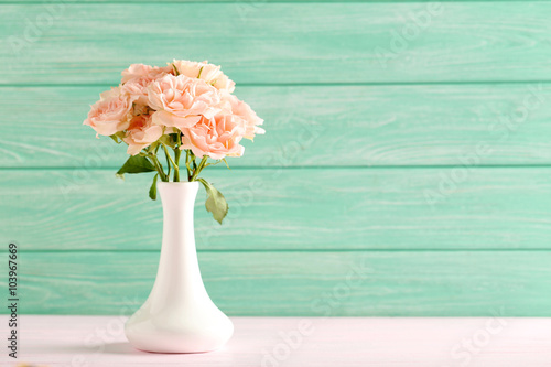 Bouquet of beautiful roses on a pink wooden table © 5second