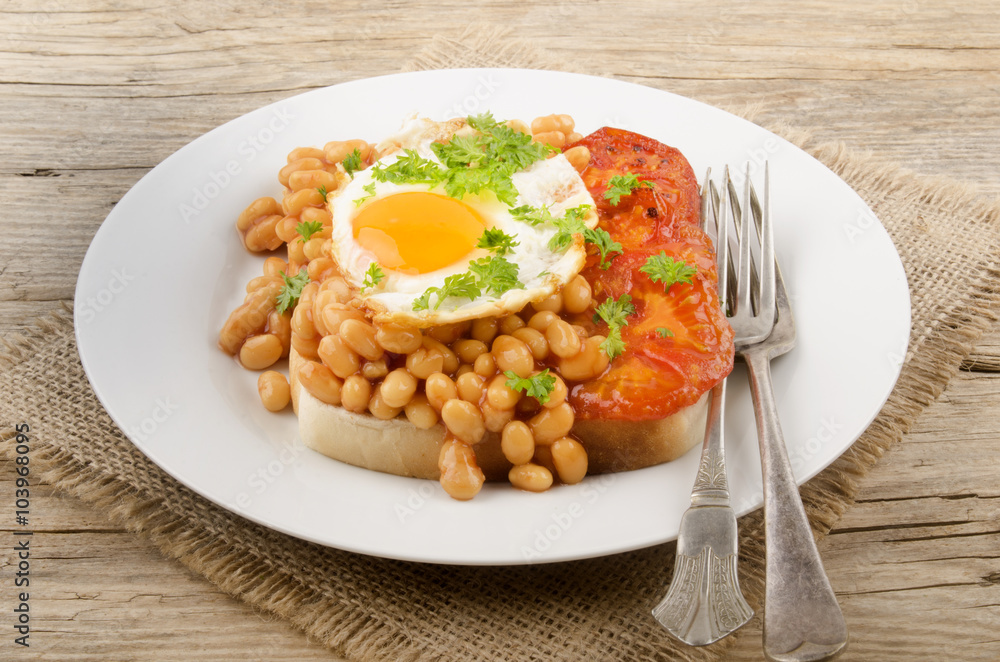fried egg with grilled tomato slices and baked beans fried egg with grilled tomato slices and baked beans