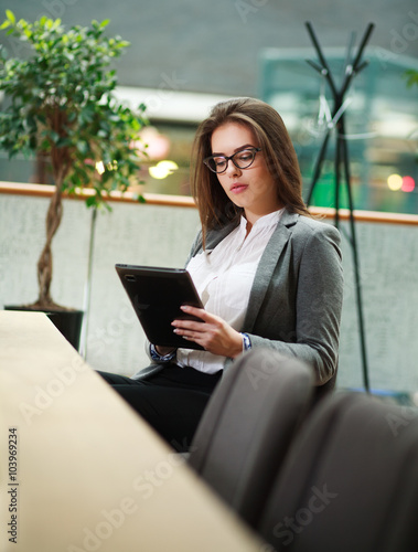 Young business woman working with the tablet in office