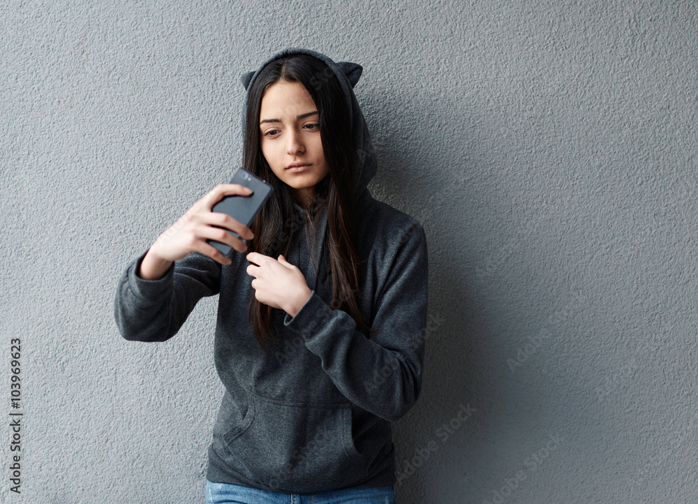 Fototapeta premium Young pretty girl taking selfie against of textured wall