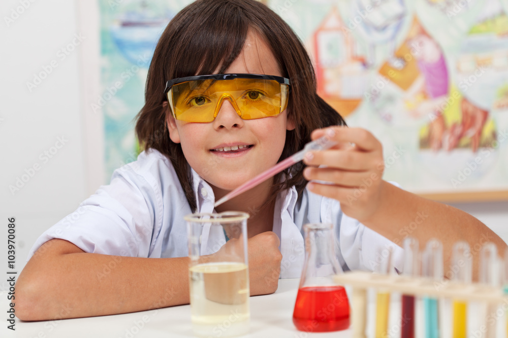 Young pupil conducting a simple chemical experiment Young pupil conducting a simple chemical experiment