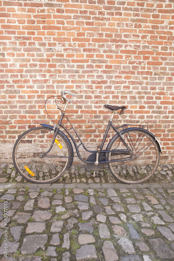 Bicycle on Cobble Stone against Brick Wall; Groot Begijnhof; Leu