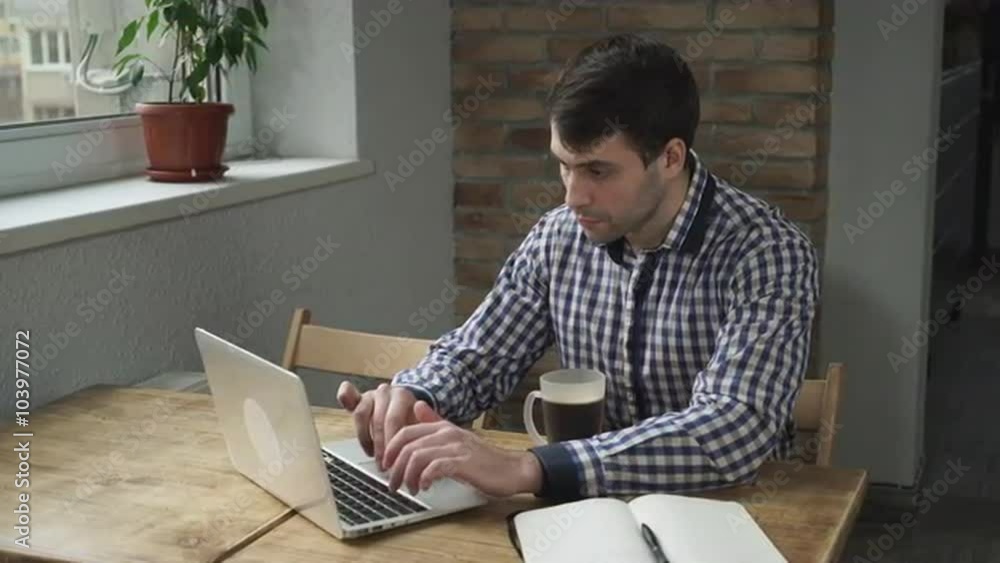 Man concentrated work at the computer and drinking coffee. Man concentrated work at the computer and drinking coffee.