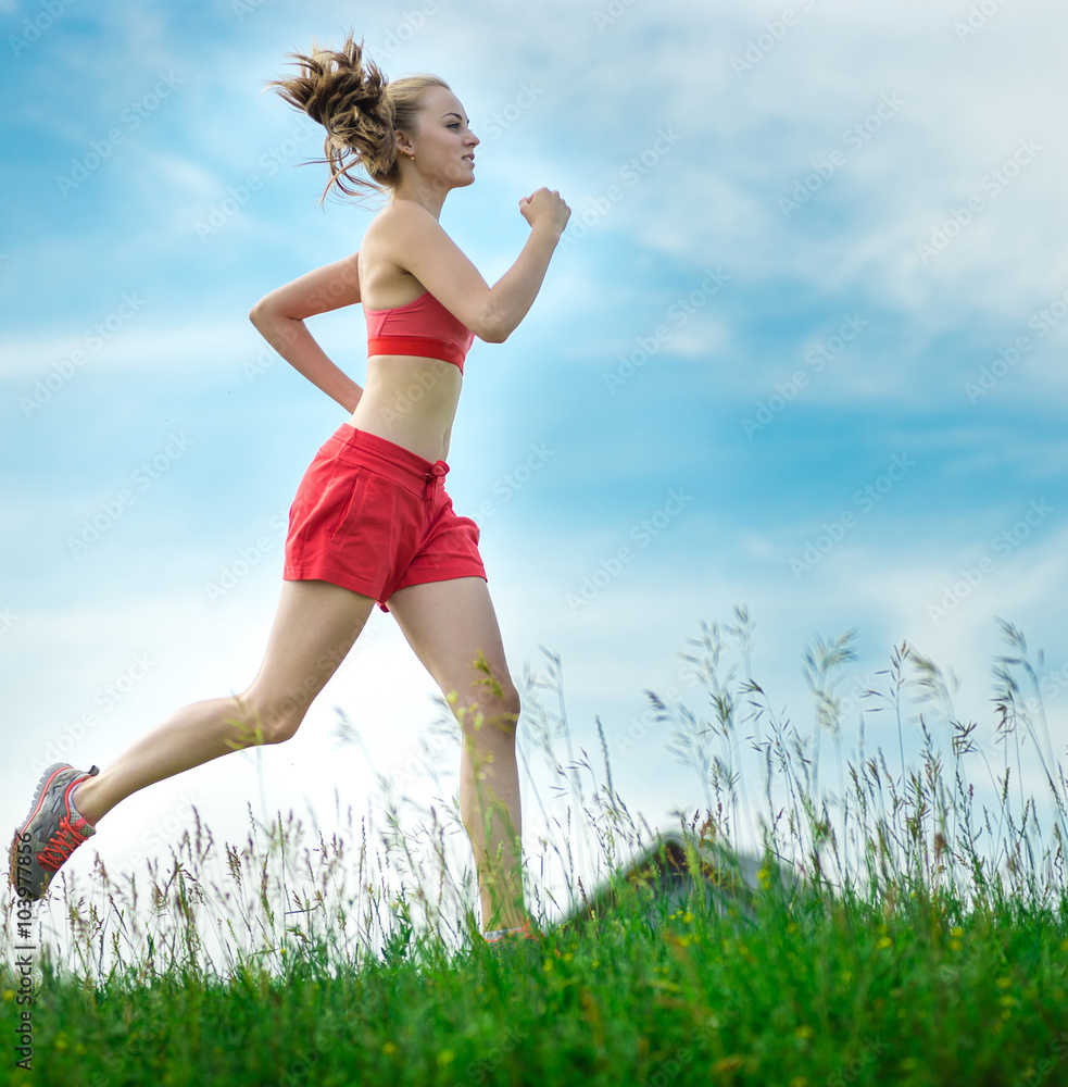 Young woman running summer park rural road. Outdoor exercises. J Young woman running summer park rural road. Outdoor exercises. J