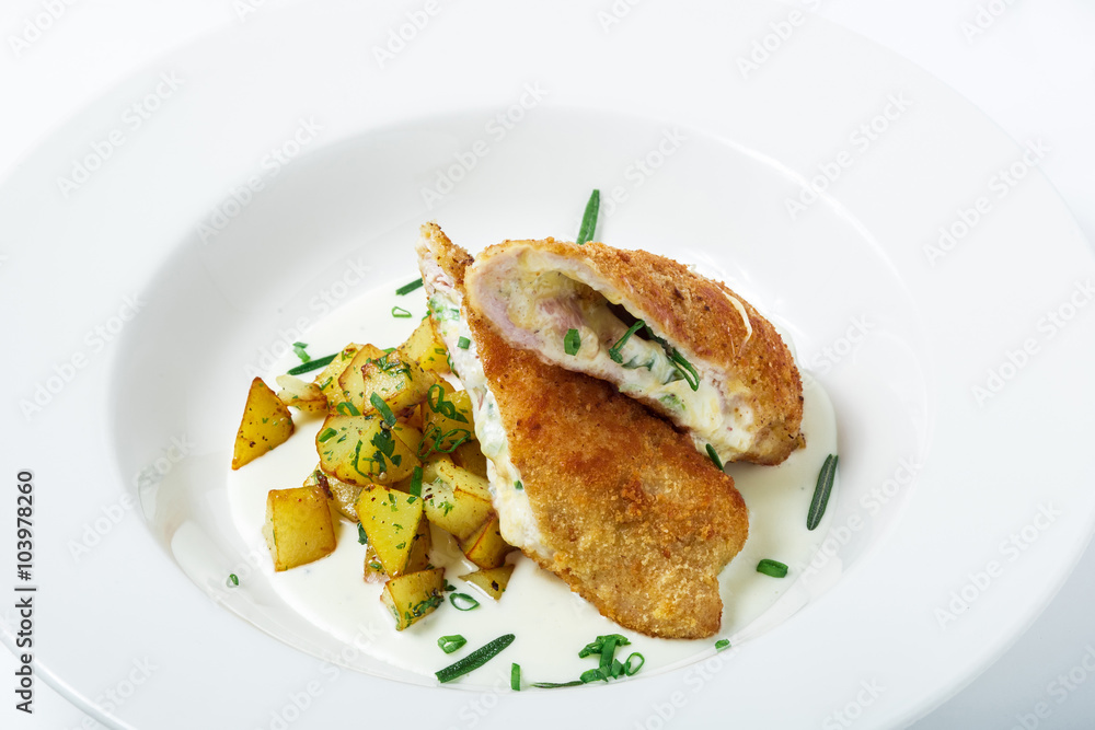 Cutting cordon bleu with cheese, turkey, crackers crumbs, potatoes. Cutting cordon bleu with cheese, turkey, crackers crumbs, potatoes.