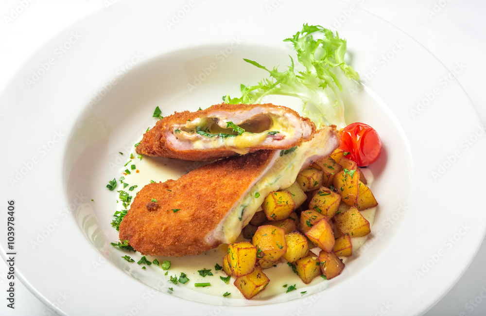 Cutting cordon bleu with cheese, turkey, crackers crumbs, potatoes. Cutting cordon bleu with cheese, turkey, crackers crumbs, potatoes.