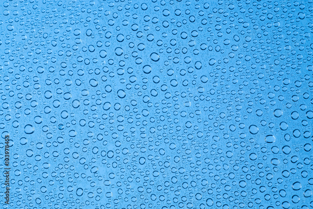 Blue background drops of water on clear glass.. Blue background drops of water on clear glass..