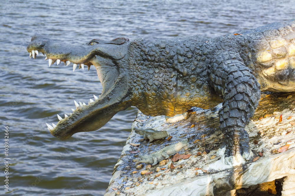 Crocodile statue water waves. Stock Photo | Adobe Stock