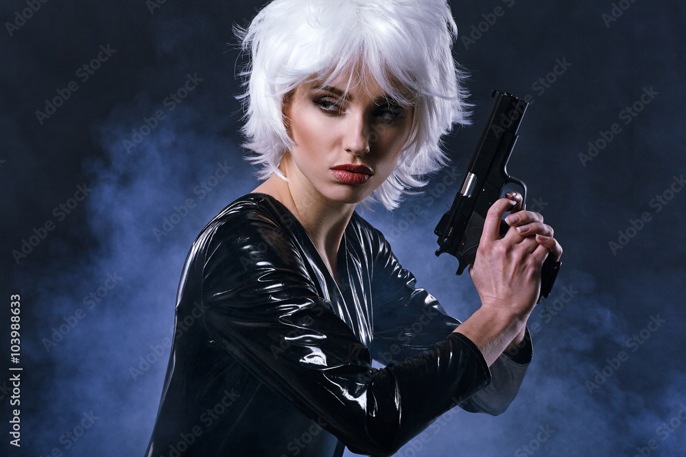 beautiful sexy girl holding gun . smoke background beautiful sexy girl holding gun . smoke background