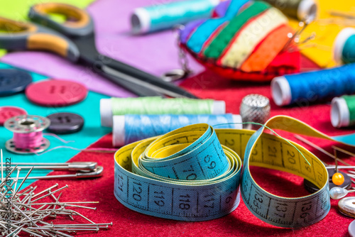 Various sewing accessories on a colored felt. photo