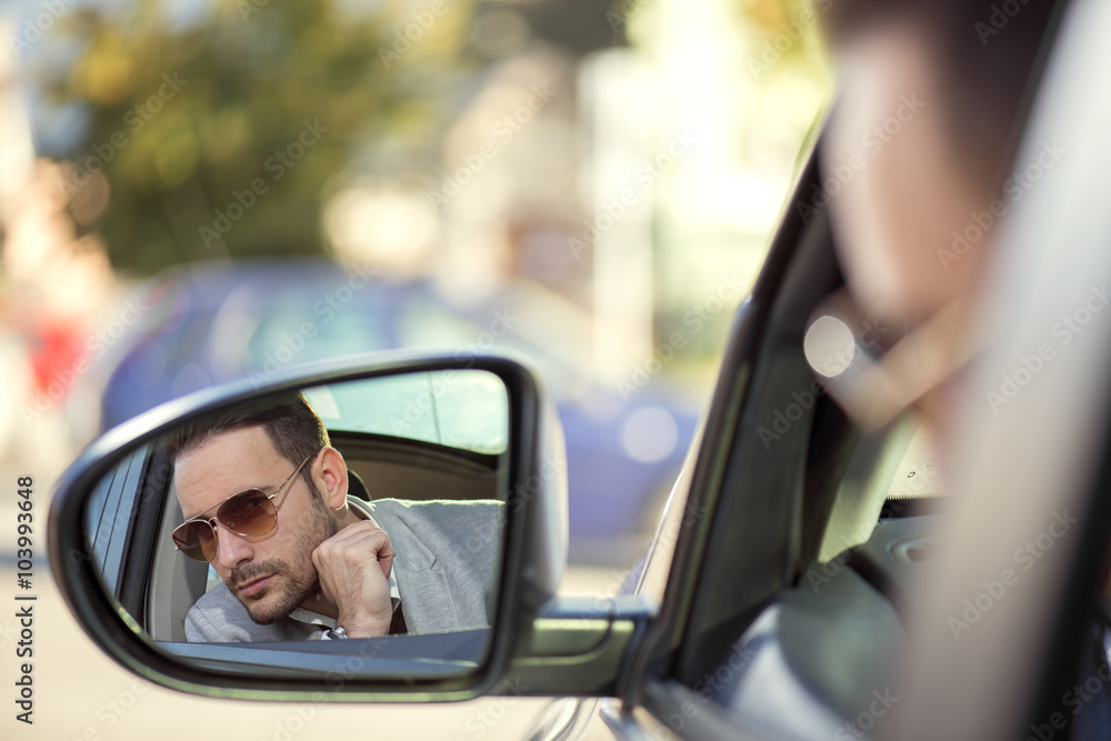 Driver in rear-view mirror